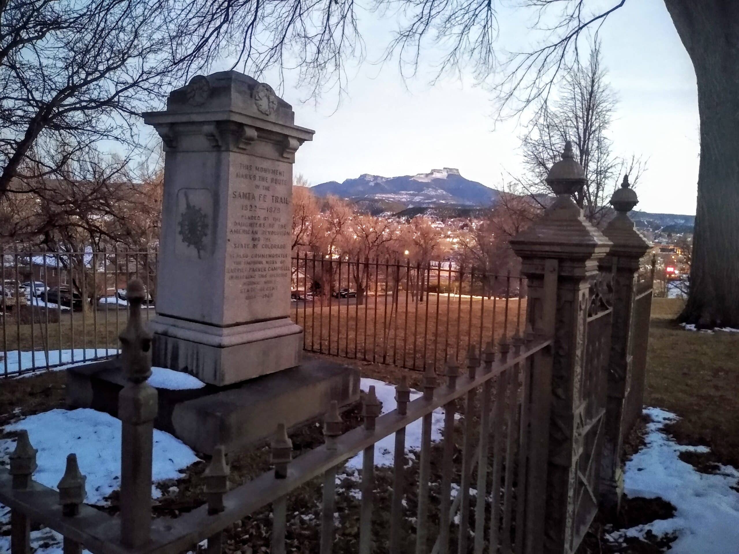 View of the Santa Fe Trail Marker in Kit Carson Park, Trinidad, Colorado, with Fisher's Peak in the background