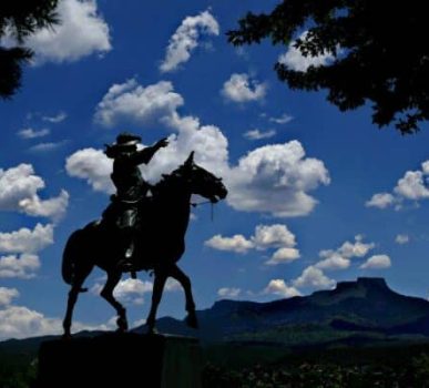 Photo of Kit Carson statue with blue sky and Fisher's Peak in background