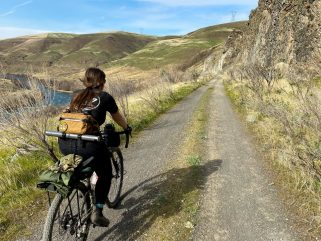 Gravel Cyclist riding along the river