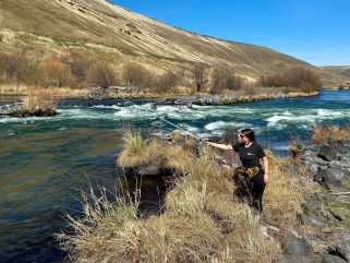 cyclist taking a break and fishing from the purgatoire river