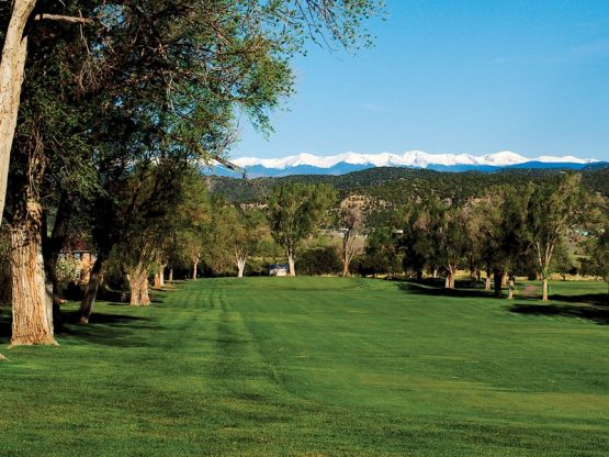 golf course fairway with rocky mountians in the background