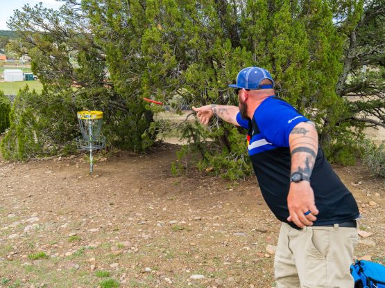 disc golfer in mid throw