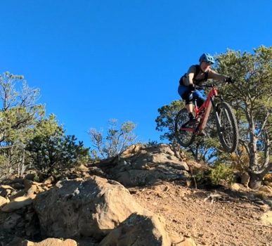 mountain biker jumping a hill at fishers peak